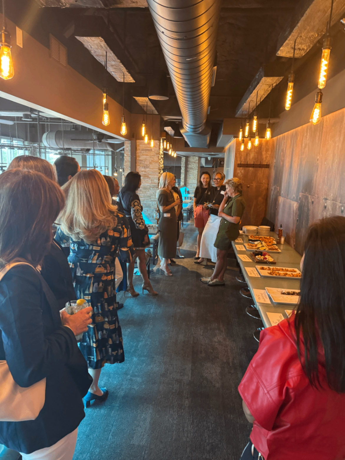 Wide view of the Toronto Summer '26 gathering with pendant lights
