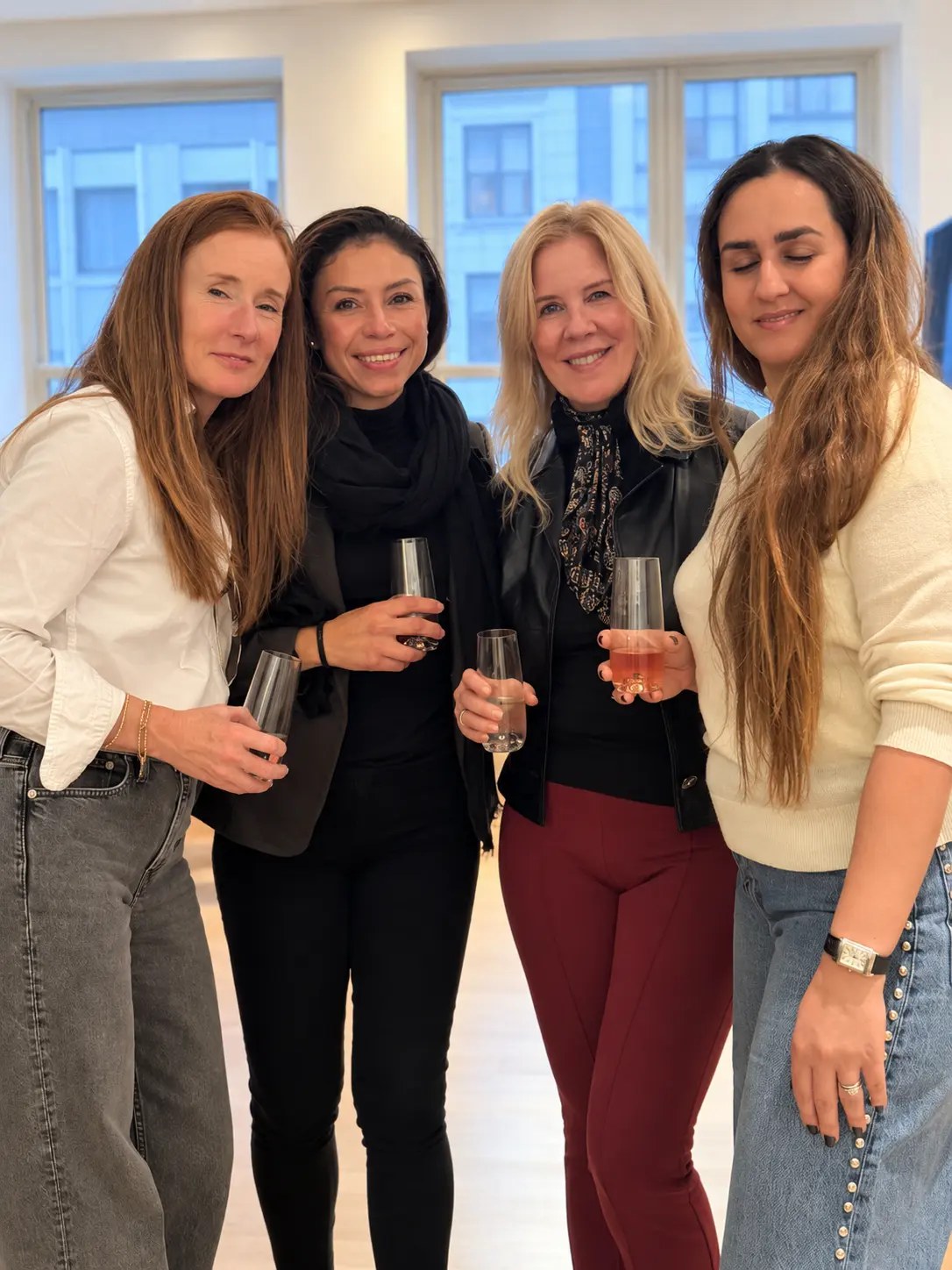 Four guests with rosé glasses at the New York October gathering