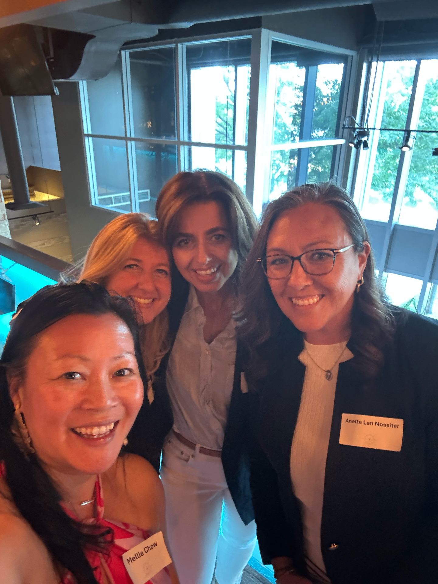 Four attendees smiling together at Toronto Summer '26