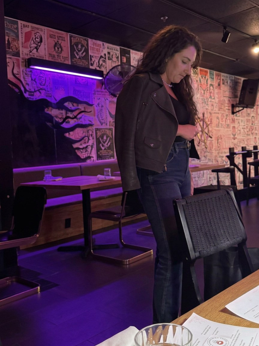 Host standing beside the table at the Philadelphia gathering